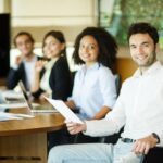 colleagues-meeting-room-posing-camera_114579-2809